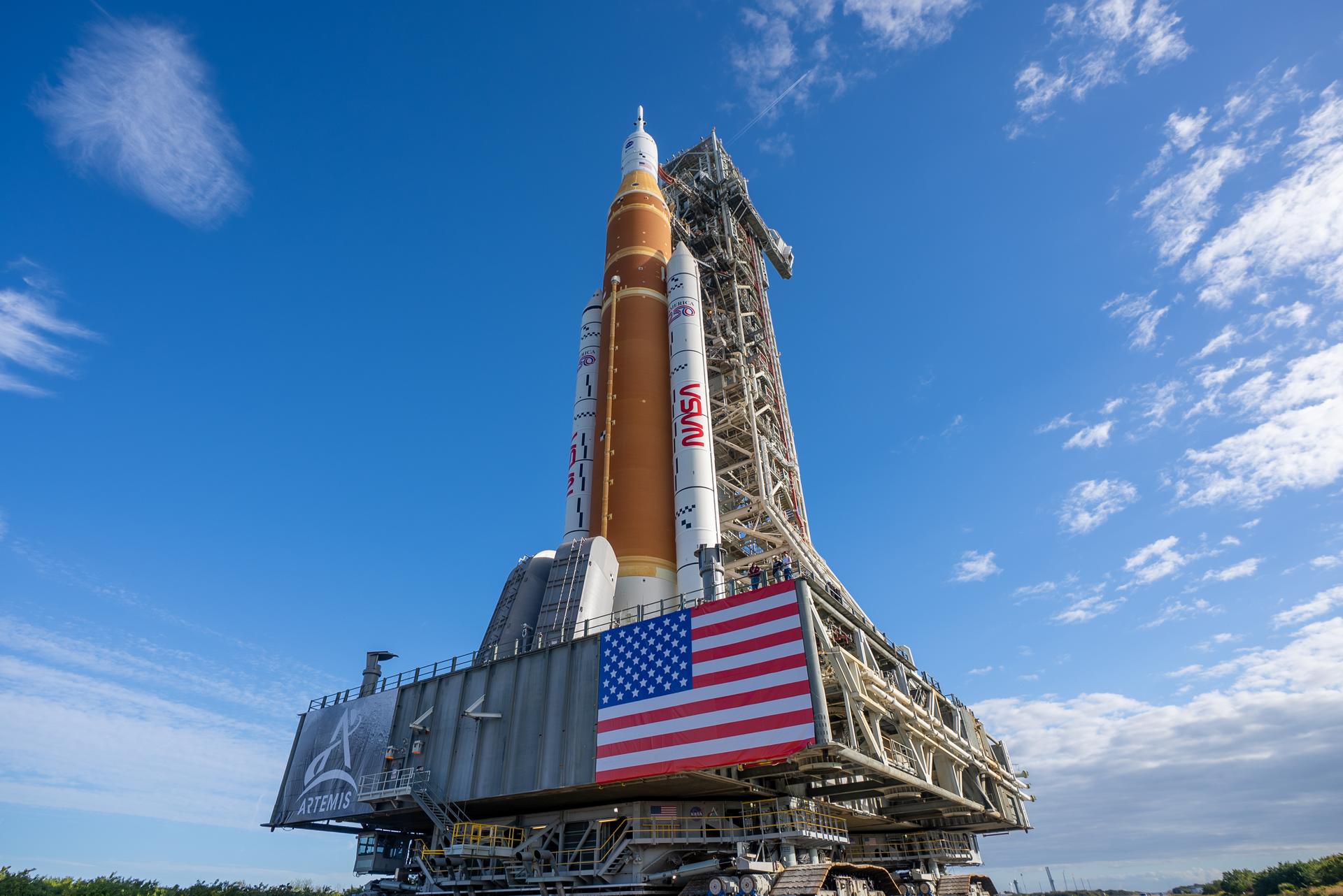 This image shows NASA’s SLS (Space Launch System) and Orion spacecraft rolling out of the Vehicle Assembly Building at NASA’s Kennedy Space Center. NASA's massive Crawler-Transporter, upgraded for the Artemis program, carries the powerful SLS rocket and Orion spacecraft on the Mobile Launcher from the Vehicle Assembly Building to Launch Pad 39B at Kennedy Space Center in preparation for the Artemis II mission.